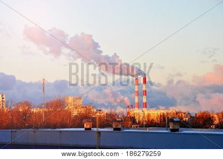 Early Morning With Down Sun Light, A View To The Industrial Landscape Of The City With Smoke Emissio