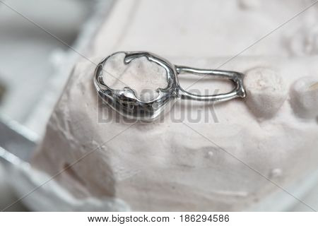 Gray dental prosthesis teeth mold clay human gums model in jaws prothetic laboratory