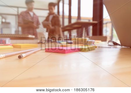 Pencil And Sticky Note On Table With Background Of Young University Students Studying With Tablet Do