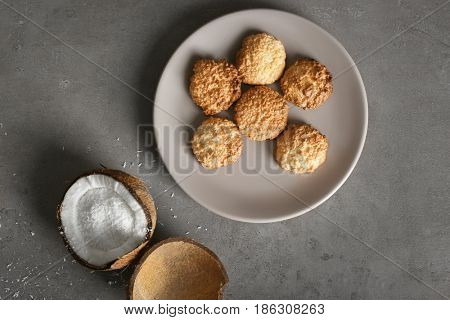 Plate with delicious coconut macaroons on table
