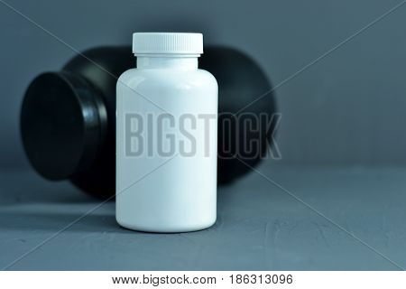 Beautiful dark background. Closed Bottle for pills.