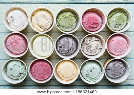 Top view Ice cream flavors in cup on background