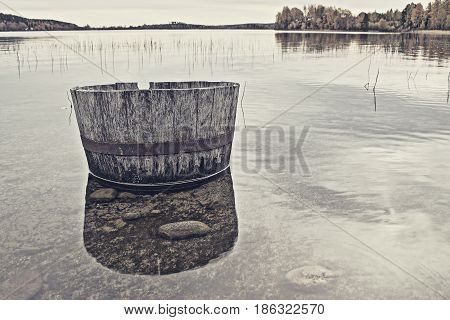 Barrell lying in the water by the beach