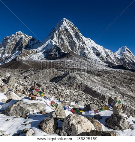 Buddhist Prayer Flags On Mountain Cairns On Everest Base Camp Route In Himalayas, Nepal. Waving Budd