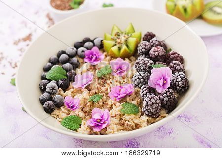 Tasty And Healthy Oatmeal Porridge With Fruit, Berry And Flax Seeds. Healthy Breakfast. Fitness Food