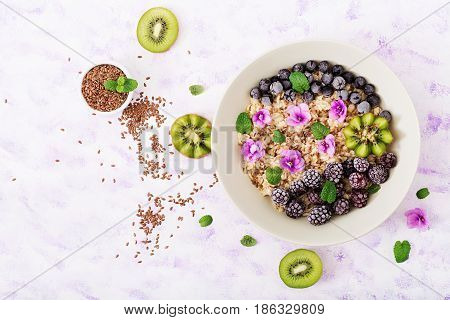 Tasty And Healthy Oatmeal Porridge With Fruit, Berry And Flax Seeds. Healthy Breakfast. Fitness Food