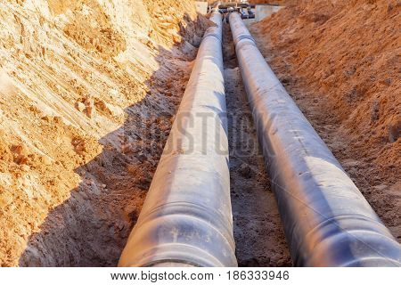 The process of installation of the distribution unit heating network. Frame for connecting pipes in the trench of sand.