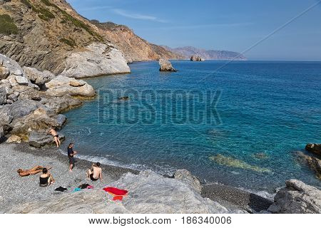 Amorgos Island Greece - October 2015: Company of young people on the beach of a Greek Island Amorgos