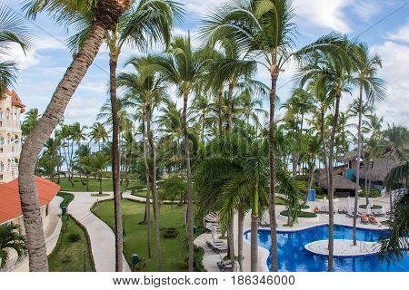 Tropical Swimming Pool And Palm Trees In Hotel