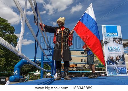 BERLIN - JUNE 11 2016: Russian Cossack with the Russian flag. German-Russian festival devoted to the Independence Day of Russia. District Karlshorst East Berlin.
