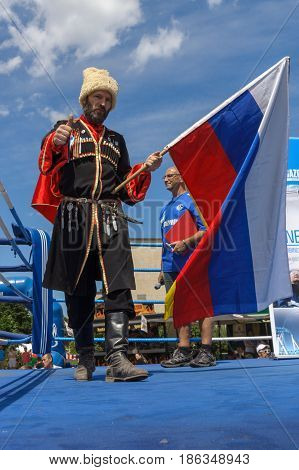 BERLIN - JUNE 11 2016: Russian Cossack with the Russian flag. German-Russian festival devoted to the Independence Day of Russia. District Karlshorst East Berlin.