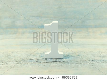 Number one on rustic wooden background. Top concept. Wooden number1 as symbol of success