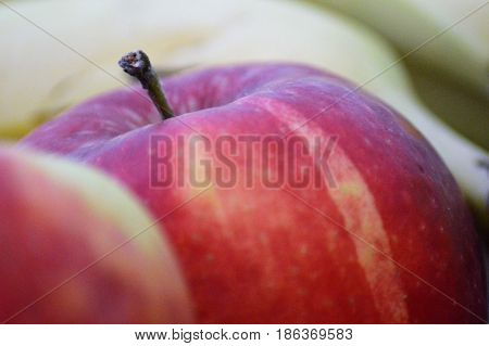 Fresh apple in close-up with banana in background