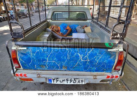 Bandar Abbas Hormozgan Province Iran - 16 april 2017: Iranian worker sleeps in a truck on the street