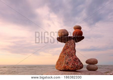 Balance stones against the sea. Rock zen in the form of scales