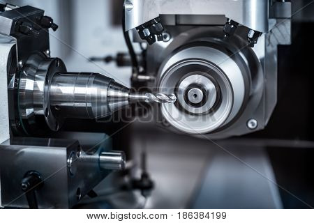 Metalworking CNC milling machine. Cutting metal modern processing technology. Small depth of field. Warning - authentic shooting in challenging conditions. A little bit grain and maybe blurred.