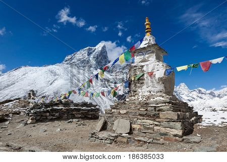 Buddhist Prayer Flags On A Buddhist Chorten On Everest Base Camp Route In Himalayas, Nepal. Waving B