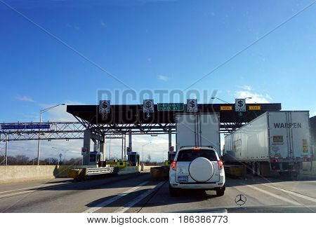 HAZEL CREST, ILLINOIS / UNITED STATES - NOVEMBER 20, 2016: Vehicles stop to pay tolls at the I-80 East Plaza 45.