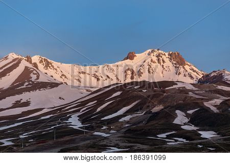 Horizontal Landscape Of Snow Covered Peak Of Erjiyes Mountain And Ski Resort In Spring With Some Sno
