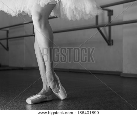 Ballerina in pointes and pack poses. Classical ballet. Prima ballerina. Shooting close-up. Black and white photography