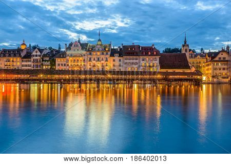 Night view towards Chapel Bridge (Kapellbruecke) together with the octagonal tall tower (Wasserturm) it is one of the Lucerne's most famous tourists attraction