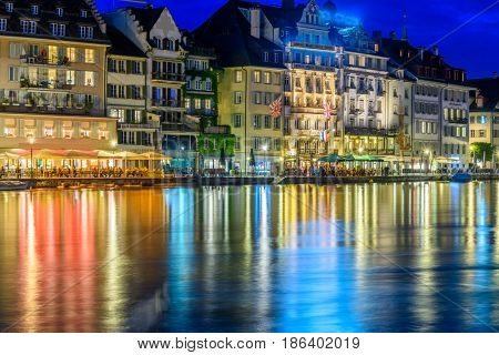 Night view towards Chapel Bridge (Kapellbruecke) together with the octagonal tall tower (Wasserturm) it is one of the Lucerne's most famous tourists attraction