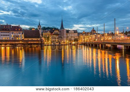 Night view towards Chapel Bridge (Kapellbruecke) together with the octagonal tall tower (Wasserturm) it is one of the Lucerne's most famous tourists attraction