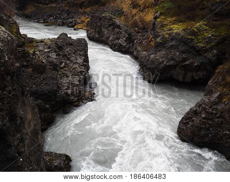 River stream near the Hraunfossar Lava Falls in early autumn Iceland