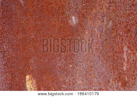 Rusty metal background with streaks of rust. Rust stains. The metal surface rusted spots