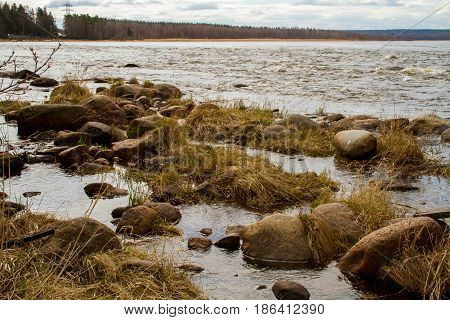 Russia. Leningrad region. Losevo. On the Vuoksa river a rocky shore with rapids and a bridge