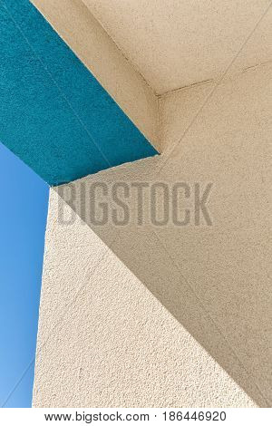 Architectural Corner detail of modern white and blue rendered building with blue sky