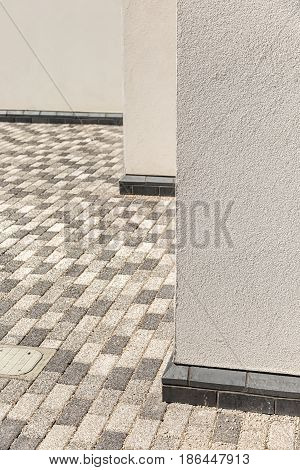 Architectural Corner detail of white modern rendered building with pavement floor pattern