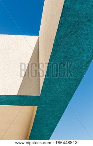 Architectural Corner detail of modern white and blue rendered building with blue sky