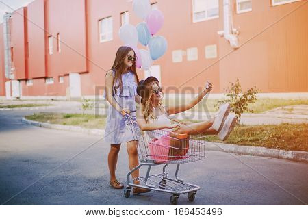 two girls walking city using communication outdoors