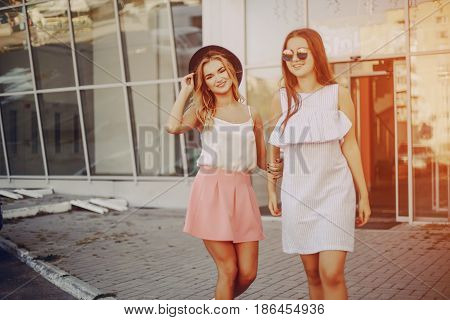 two girls walking city using communication outdoors