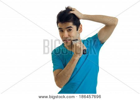 young cheerful man in blue shirt shaving his face isolated on white background