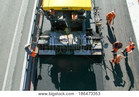Workers And Vehicles During The Asphalting Of The Highway