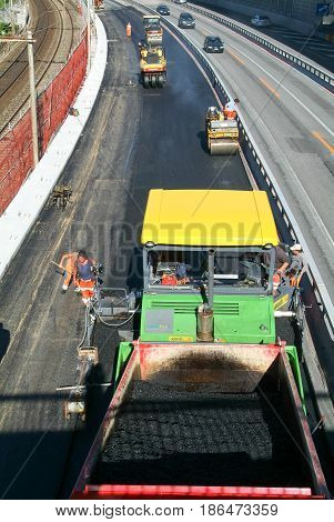 Workers And Vehicles During The Asphalting Of The Highway