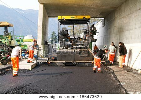 Workers And Vehicles During The Asphalting Of The Highway