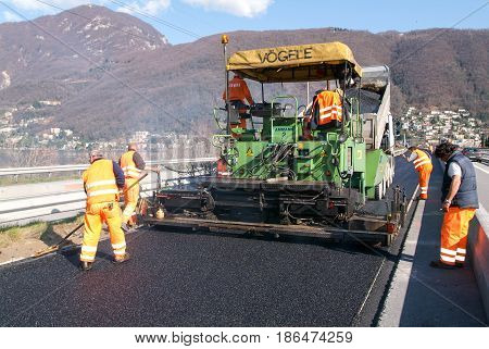 Workers And Vehicles During The Asphalting Of The Highway