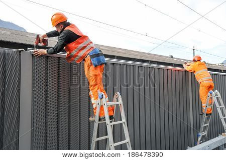 Workers During The Installation Of Noise Barriers On The Railway