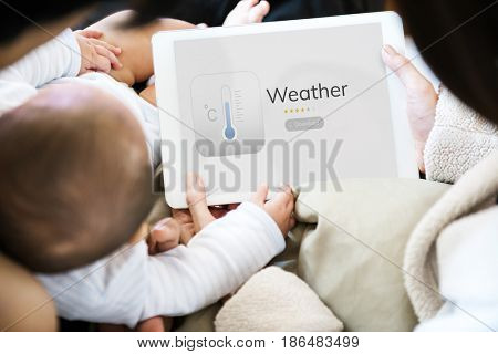 Baby using digital device with parent network graphic overlay