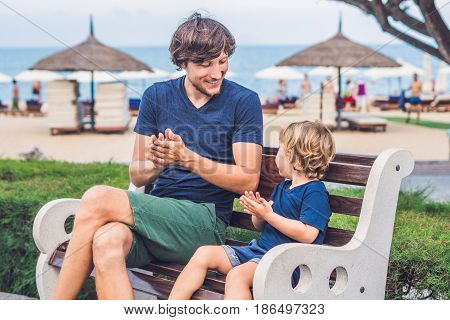 Father And Son Eat Fried Sweet Potatoes In The Park. Junk Food Concept