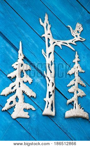 Background pattern cut out of cardboard on the wall of the old blue wooden boards