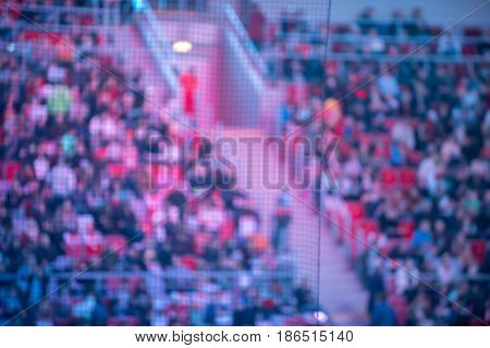 Blurred crowd of spectators on a stadium bleachers at a sporting event