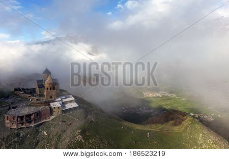 Gergeti Trinity Church Or Tsminda Sameba - Holy Trinity Church Near Village Of Gergeti In Georgia. Church Is Situated At An Elevation Of 2170 Meters Under Mount Kazbegi. Spring Or Summer Season.