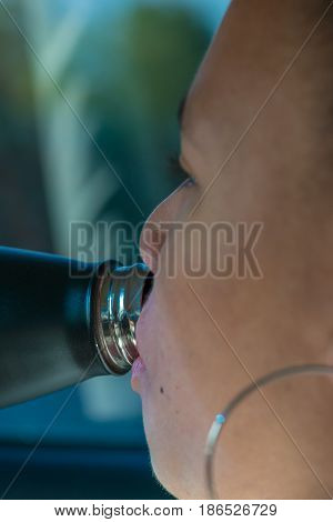 Girl having a drink of water close up