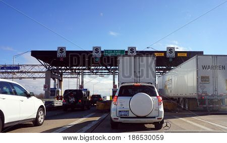 HAZEL CREST, ILLINOIS / UNITED STATES - NOVEMBER 20, 2016: Vehicles stop to pay tolls at the I-80 East Plaza 45.