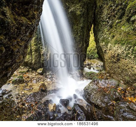 Beautiful waterfall in a narrow gorge. Allgau Alps.