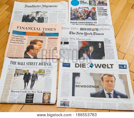 PARIS FRANCE - MAY 10 2017: Multiple international newspapers front page covers with the picture of the newly elected French president Emmanuel Macron the 8th President of France